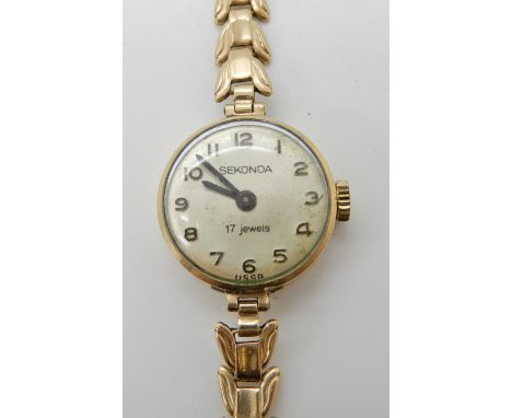 A 9ct gold ladies Certina watch, weight 12.4gms Condition Report: Winds and is ticking, strap a nd case ok.  