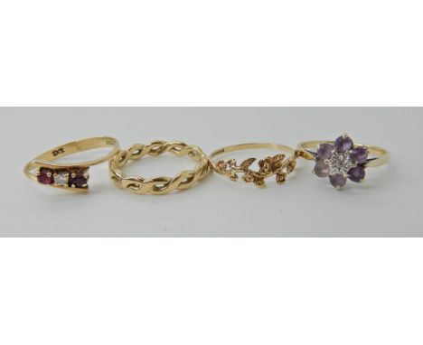 A 9ct gold amethyst and diamond flower ring, size N1/2, a 9ct gold ruby and diamond ring, size O, a 9ct flower ring size N an