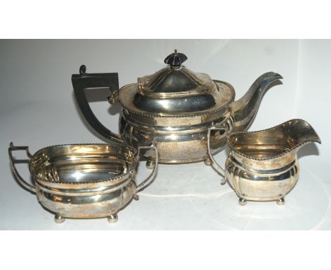 A three piece silver tea service by Adie Bros Limited, Birmingham 1927 of rounded rectangular form, 944gms Condition Report: 