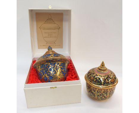 A Thai ceramic box and cover handpainted with blue and gilt blowers and birds, 18cm high, in original box, and another simila