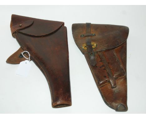 Two brown leather gun holsters, map pouch and various gaiters Condition Report: Available upon request