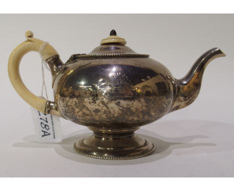 A silver teapot by John King, London 1859, of bulbous shape with scrolling ivory handle and ivory finial, bearing a crest, 11