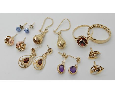 A 9ct gold garnet flower ring size L, a 9ct gold rope design ring, size M and a collection of gold and yellow metal earrings 