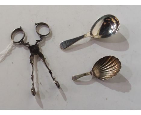 A silver caddy spoon by Elizabeth Eaton, London 1850, 9.5cm long with another caddy spoon and a pair of white metal sugar nip