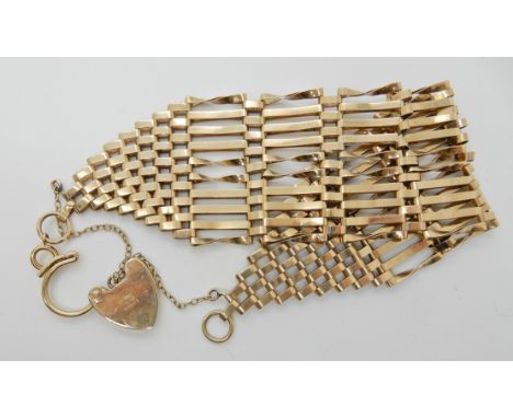 A 9ct gold wide gate bracelet with heart shaped clasp, length approx 20cm, weight 19.6gms Condition Report: Light general wea