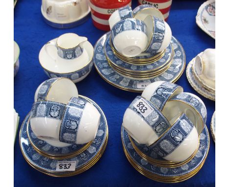 A Wedgwood teaset with transfer print decoration comprising; eleven cups, eleven saucers and twelve plates, milk jug, sugar b