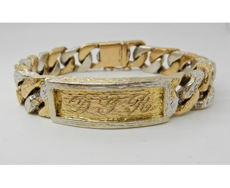 A gents 9ct yellow and white gold identity bracelet with bark textured finish, engraved to front panel, DGR. Length approx 22