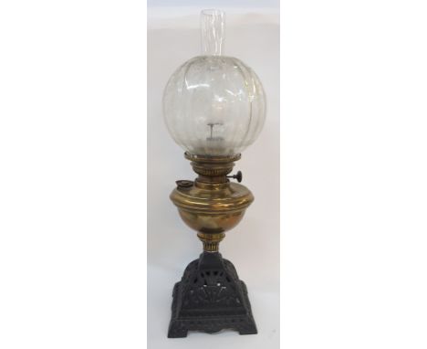A brass and cast iron paraffin lamp with etched glass shade, 60cm high Condition Report: Available upon request