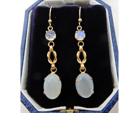 A pair of yellow metal lovers knot moonstone set earrings, length 5.5cm, weight 6.2gms Condition Report: Light general wear. 