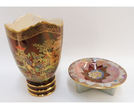 A small Carlton Ware dish on tripod base, decorated in enamels and gilt with flowers on a pink and blue ground, 11cm diameter