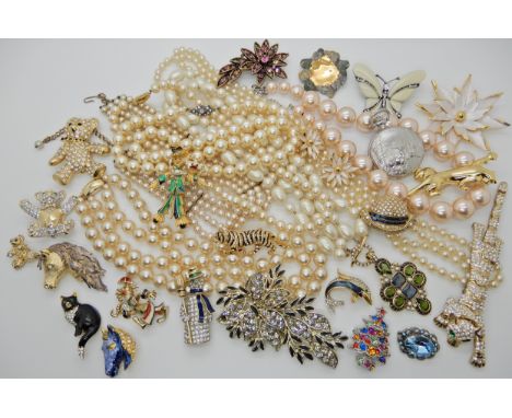 A box of vintage costume jewellery to include character brooches, pearls etc Condition Report: Available upon request