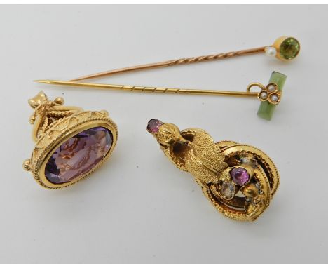 A 9ct gold amethyst set fob seal, a New Zealand jade and pearl shamrock pin, a further pin set with peridot and pearl and a y