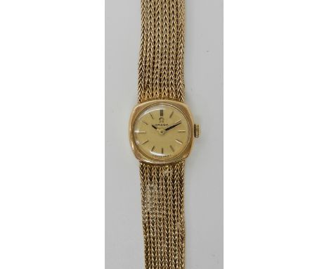 A 9ct gold ladies Omega watch with integral woven strap, length 17cm, weight including mechanism 23gms Condition Report: Wind