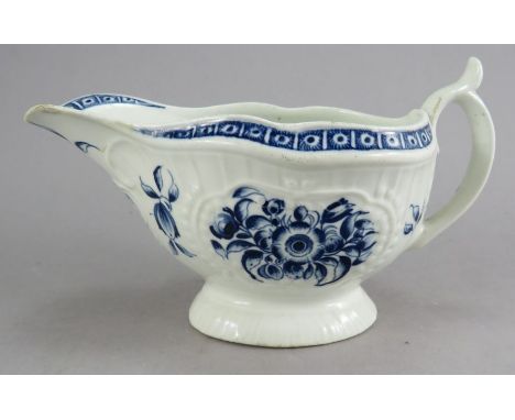 A late nineteenth century Worcester blue and white sauce boat, c. 1770. It is decorated with flowers over a moulded paneled f