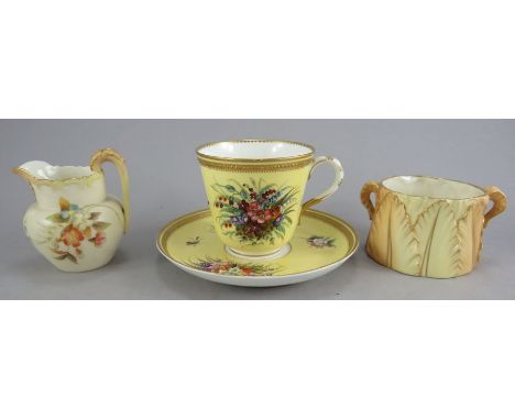 A late nineteenth century Royal Worcester yellow ground porcelain cup and saucer with raised gilding and hand-painted flowers