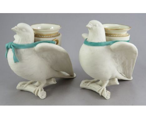 Two similar Royal Worcester vases each modelled as a dove perched on a branch supporting a ribbon tied amphora with jewelled 