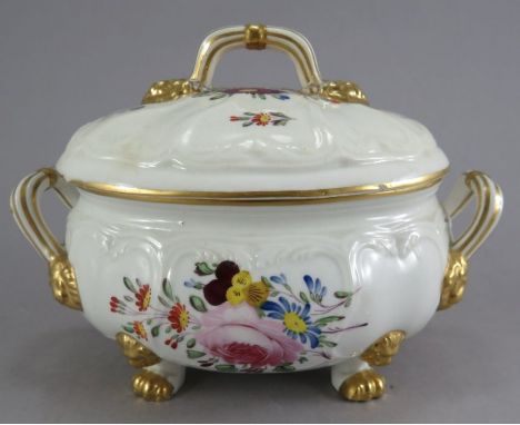An early nineteenth century Derby two-handled sauce tureen, c. 1825. It is of moulded form and standing four lion paw feet wi