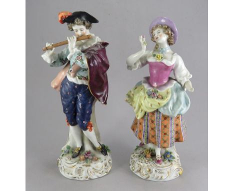 A pair of late nineteenth century Continental porcelain figures, c. 1880. They depict a lady and gentleman, the latter playin