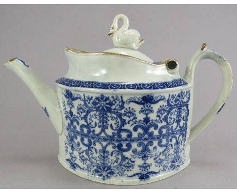 An early nineteenth century blue and white transfer-printed floral teapot with hinged cover and swan knop, possibly Bovey Tra