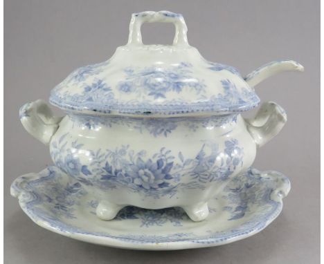 A mid-nineteenth century blue and white transfer-printed sauce tureen cover, stand and ladle, c. 1850. It s decorated with th
