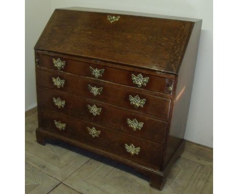 18th/19th C oak bureau with fall front revealing fitted interior above four long drawers on raised bracket feet (104cm x 50cm