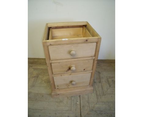 Pine three drawer bedside chest on step base (lacking top) (46cm x 43cm x 74cm)