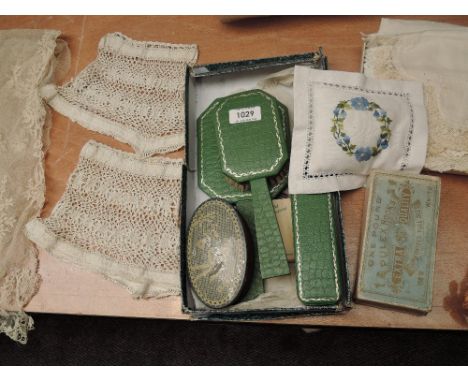 A selection of vintage dressing table items, an advertising box of antique hook and eyes, pin cushion, lace and handkerchiefs