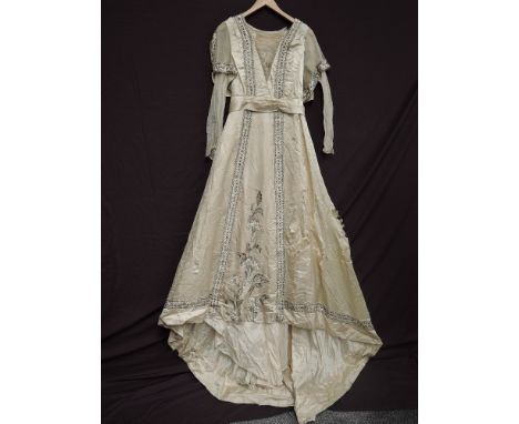 A cream silk wedding dress around 1915-1920, having abundant rhinestone and beaded detailing throughout, lace panel to bodice