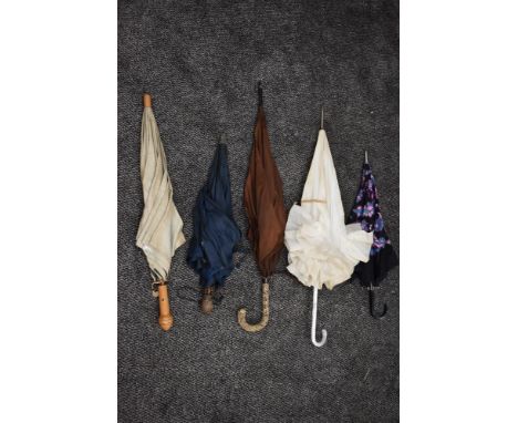 Five vintage umbrellas including frilled lucite handled example, bright floral and one having wooden parrots head to handle.