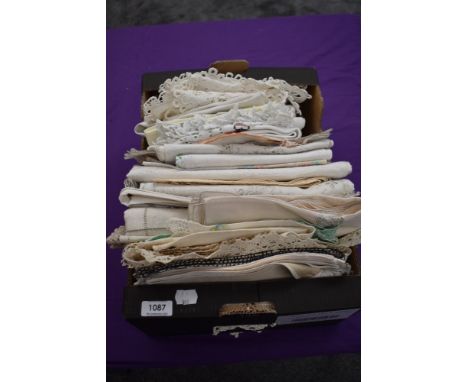 A box full of vintage and antique table linen and similar, some edged in crotchet, others with embroidery, tray cloths, mats,