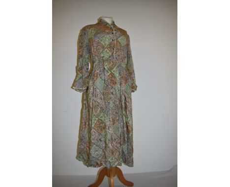 A vintage 1940s printed day dress having buttons to front, long sleeves and side metal zip, Morphelia label, larger size.