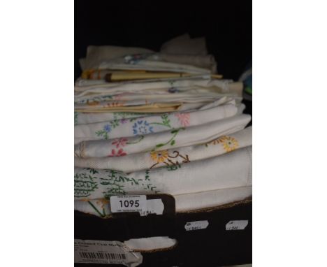 A full box of vintage and antique embroidered table cloths, tray cloths and similar.