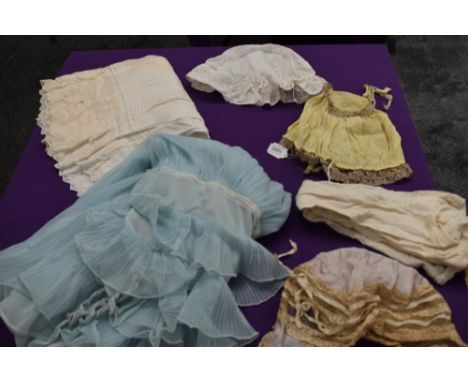 A miscellany of items consisting of vintage and antique bonnets, 1960s nylon baby doll, white cotton stockings and children's