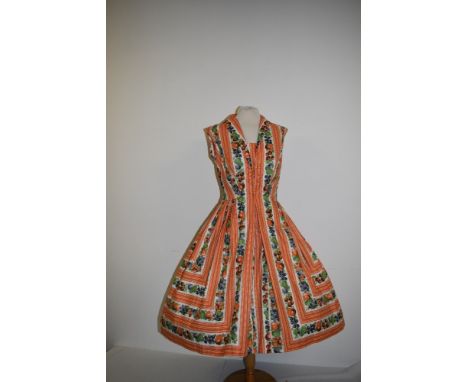 A vintage 1950s Berkertex overseas Continentals cotton day dress having bold novelty fruit print in orange, grey and green, l