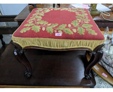 A Victorian rosewood stool with tapestry upholstered top on carved cabriole legs with scrolled end feet Location:If there is 