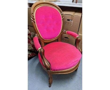 An early 20th century mahogany framed upholstered open armchair with carved decoration, upholstered armrests on carved front 