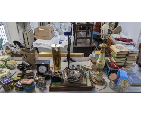 A mixed lot to include a slate mantel clock, a silver plated teapot with milk jug, vintage tins, a WWI shell case and other i
