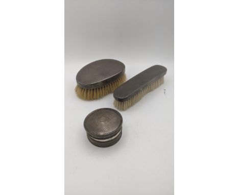 Silver to include a ring box hallmarked Birmingham 1917, together with two silver dressing table brushes with engine turned d