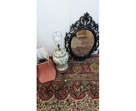 A modern Chinese table lamp with panels of flowers with a shade and a black plastic framed mirrorLocation:GIf there is no con