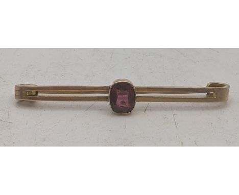 A 9ct yellow gold bar brooch set with an oval cut amethyst coloured stone 3.5g Location:If there is no condition report shown