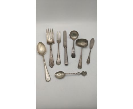 Silver cutlery and flatware to include two sauce ladles, a butter knife with weighted handle, a sterling silver fish fork, a 