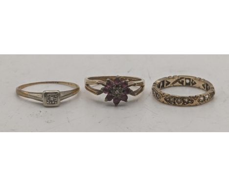 Three gold ladies rings to include a 9ct gold example set with ruby pink coloured stones, together with a yellow gold and pla
