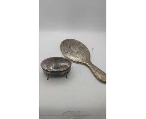 Two silver dressing table items to include an oval shaped ring box on four feet having a hinged lid hallmarked Birmingham 193