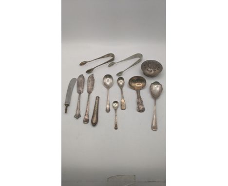 A group of mixed silver to include a tea caddy spoon hallmarked London 1826, along with a pair of sugar tongs and others, alo