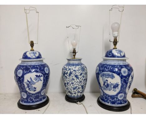 A pair of modern Chinese blue and white inverted baluster table lamps on ebonized wooden bases, and another Oriental blue and