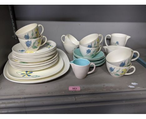 A part Poole pottery dinner service to include cups, saucers, dinner plates, meat plates and other items, decorated with blue