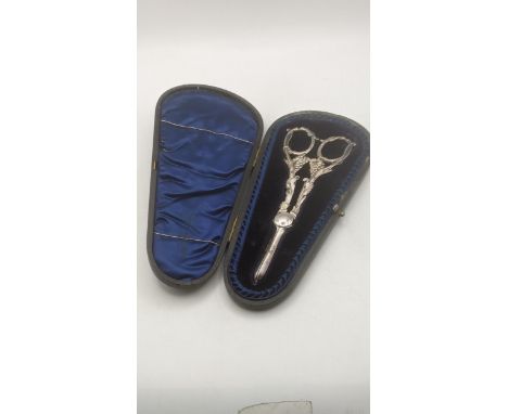 A Levesley Brothers pair of silver grape scissors hallmarked Sheffield 1898 having cast vine and grape handles in a fitted ca