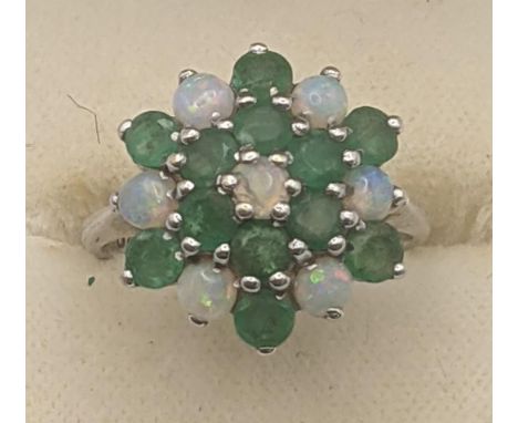 12 emerald and seven opal cluster flower head ring in a 9ct white gold claw setting and shank, size M 1/2, 4g Location:If the