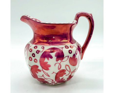 Cream colored pitcher with pink lustre decorations around jug and handle.Wedgwood of Etruria and Barlaston backstamp to base.