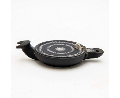 Black dip roman lamp of oval form, with a fish-tail handle. The lid is decorated with anthemion and face of a woman.Wedgwood 